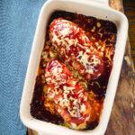 Overhead British hunters chicken stuffed with cheddar cheese, wrapped in bacon and cooked in BBQ sauce.