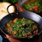 Lamb saag or saagwala (lamb and spinach curry) with naan and coriander.