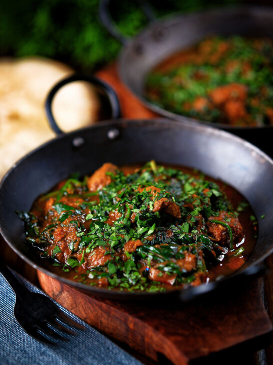 Lamb saag or saagwala (lamb and spinach curry) with naan and coriander.