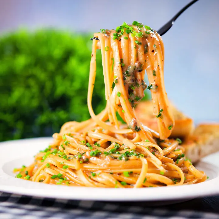 Miso butter pasta with black & pink peppercorns and snipped chives served with garlic bread.