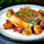 Pan fried curried cod fillet with aloo jeera and tomato and onion salad.