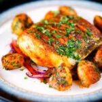 Pan fried curried cod fillet with cumin potatoes and tomato & onion salad.