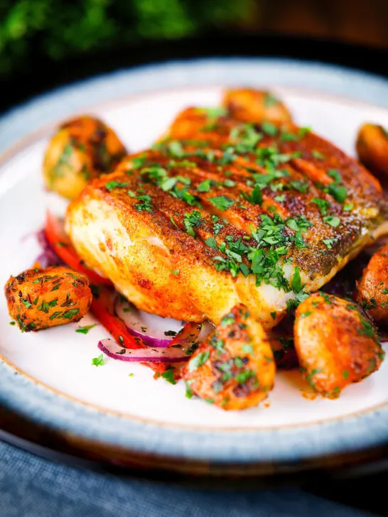 Pan fried curried cod fillet with cumin potatoes and tomato & onion salad.