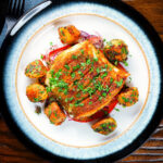 Overhead pan fried curried cod fillet with aloo jeera and tomato & onion salad.