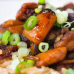 Close-up spicy Shanghai chicken stir fry served with egg fried rice.