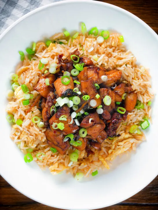 Close-up overhead spicy Shanghai chicken stir fry served with egg fried rice.