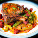 Basque piperade pepper and tomato stew served with Spanish pork chops and chorizo.