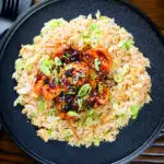 Overhead teriyaki king prawns (shrimp) stir fry served with egg fried rice.