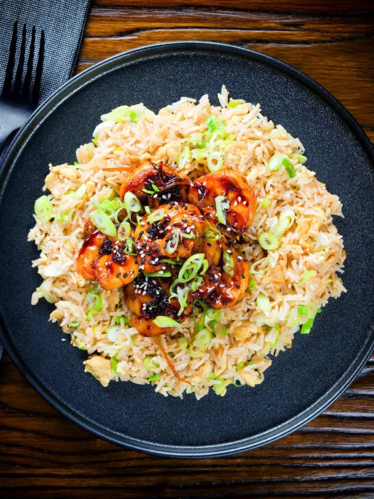 Overhead teriyaki king prawns (shrimp) stir fry served with egg fried rice.