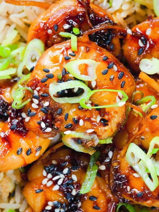 Close-up overhead teriyaki king prawns (shrimp) stir fry served with egg fried rice.