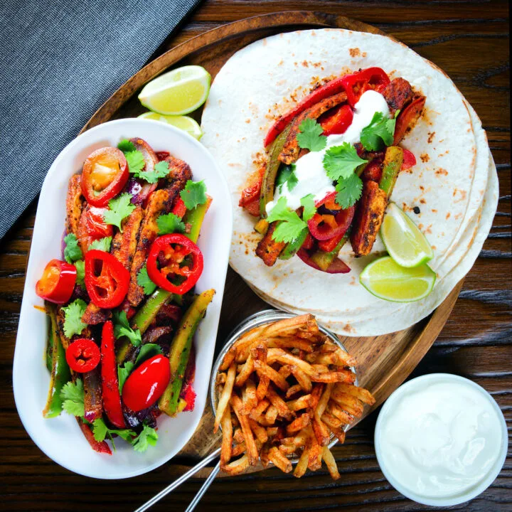 Spicy Mexican influenced halloumi cheese and vegetable fajitas with sour cream and lime.