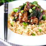 Beef and broccoli stir fry served with egg fried rice.