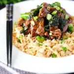 Beef and broccoli stir fry served with egg fried rice.