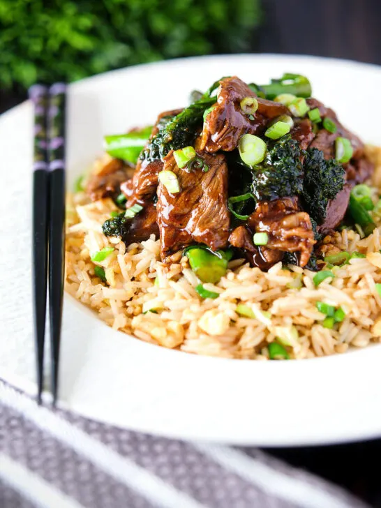 Beef and broccoli stir fry served with egg fried rice.