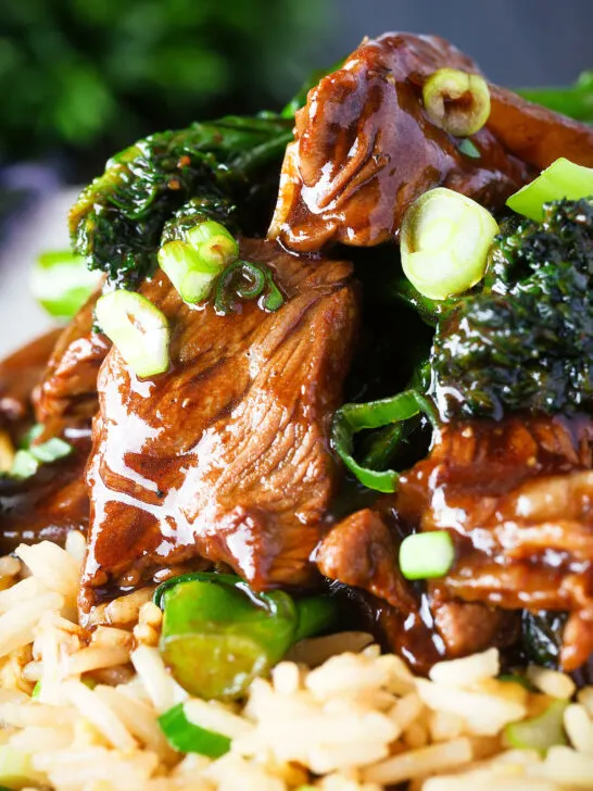 Close up beef and broccoli stir fry garnished with spring onions.