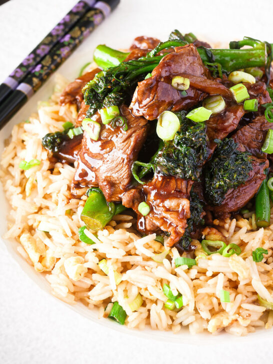 Close up beef and broccoli stir fry served with egg fried rice.