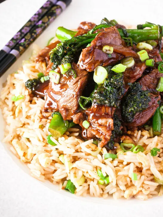 Close up beef and broccoli stir fry served with egg fried rice.