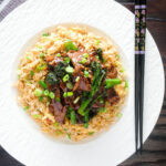 Overhead beef and broccoli stir fry served with egg fried rice.