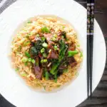 Overhead beef and broccoli stir fry served with egg fried rice.