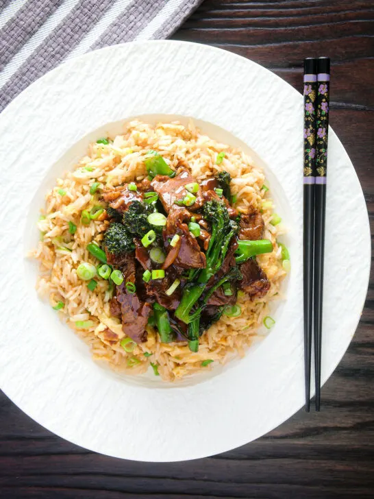 Overhead beef and broccoli stir fry served with egg fried rice.