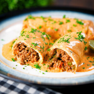 Hortobágyi palacsinta Hungarian Meat (minced beef) stuffed pancakes in a sour cream and paprika sauce.