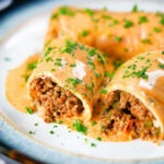 Hortobágyi palacsinta Hungarian meat stuffed pancakes in a sour cream and paprika sauce.