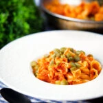 Hungarian potato and paprika pasta (Krumplis Teszta) served with pickles.