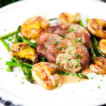 Pan fried pork tenderloin medallions with a cider, mustard and camembert sauce, new potatoes and asparagus.