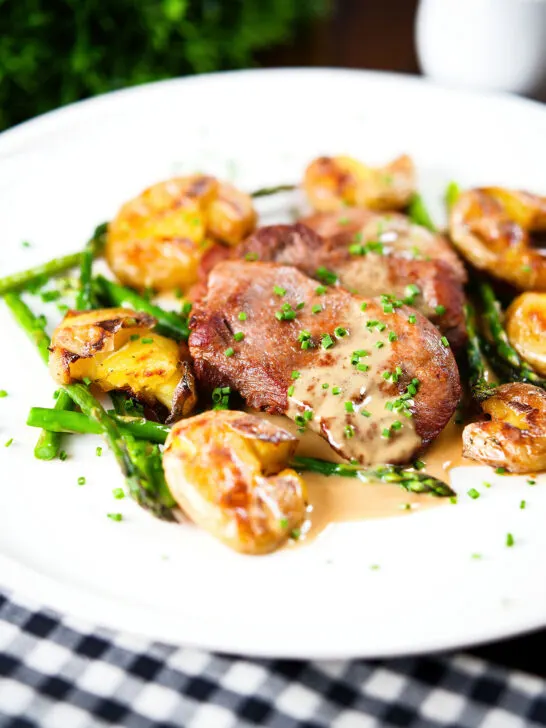 Pan fried pork tenderloin medallions with a cider, mustard and camembert sauce, new potatoes and asparagus.