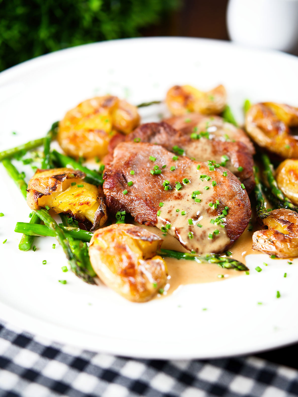 Pan fried pork tenderloin medallions with a cider, mustard and camembert sauce, new potatoes and asparagus.