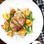 Overhead pork tenderloin medallions with a cider, mustard and camembert sauce, new potatoes and asparagus.