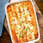 Overhead baked three cheese, pork sausage, leek and ricotta stuffed cannelloni.