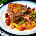Spanish influenced pork chops with chorizo served with Basque piperade and fresh parsley.