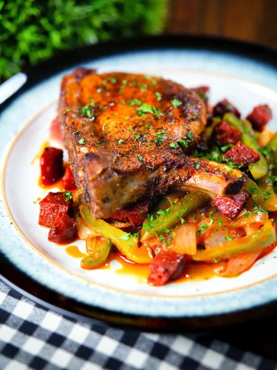 Spanish influenced pork chops with chorizo served with Basque piperade and fresh parsley.
