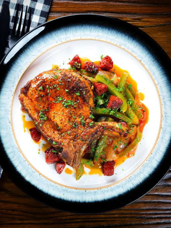 Overhead Spanish influenced pork chops with chorizo served with Basque piperade.