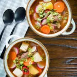 Overhead Korean beef doenjang jjigae stew with vegetables and tofu.