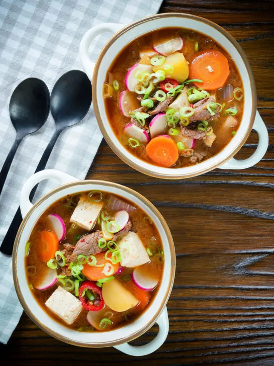 Overhead Korean beef doenjang jjigae stew with vegetables and tofu.