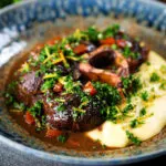 Beef shin (shank) osso buco served with polenta and gremolata.