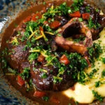 Close-up beef shin (shank) osso buco served with polenta and gremolata.