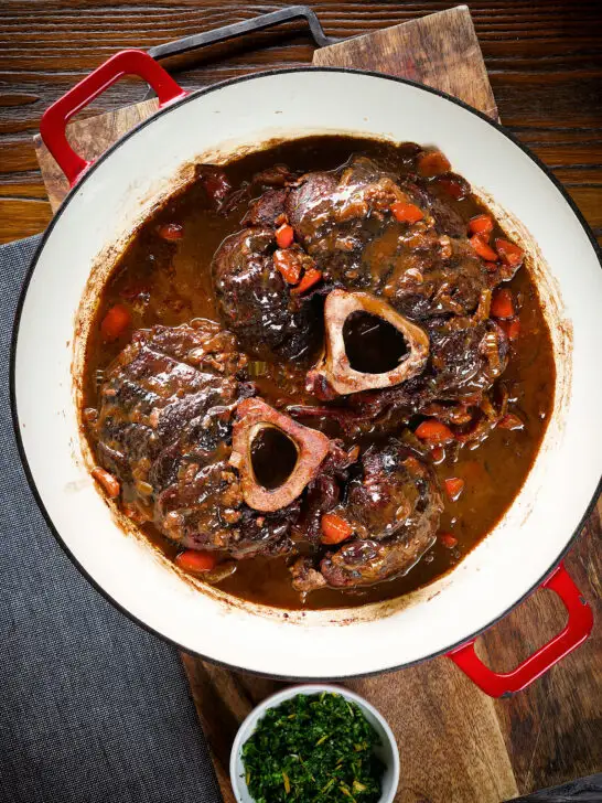 Overhead beef shin (shank) osso bucco served in its cooking pan.