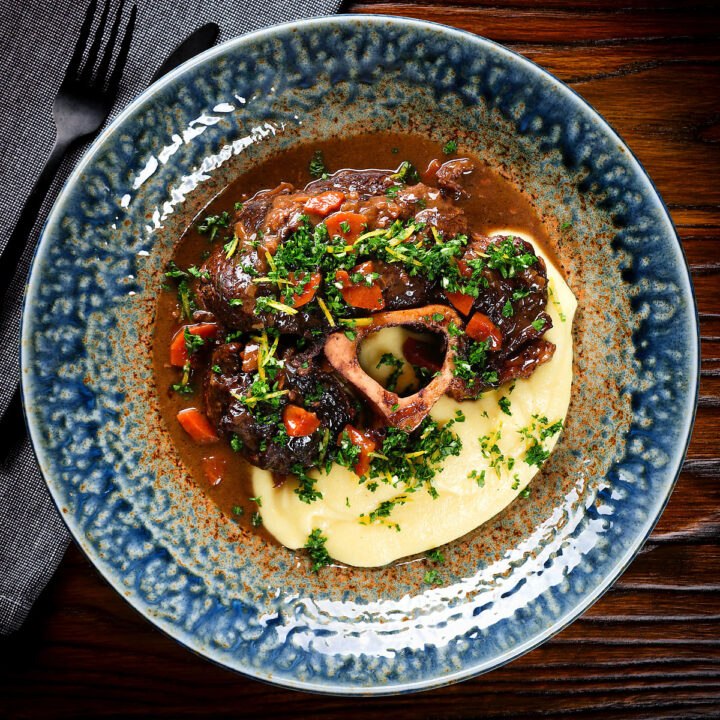 Bone in braised beef shin (shank) osso buco served with polenta and gremolata.