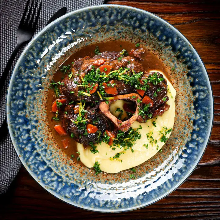 Bone in braised beef shin (shank) osso buco served with polenta and gremolata.