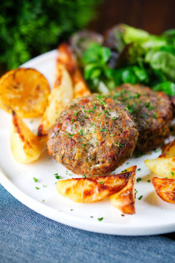 Baked Greek bifteki patties with lemon roasted potatoes and salad.