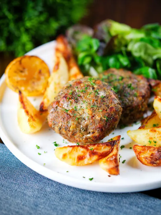 Baked Greek bifteki patties with lemon roasted potatoes and salad.