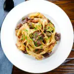 Overhead chicken liver and mushroom pasta with sage, balsamic vinegar and butter.