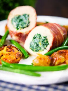 Chicken wrapped in Parma ham stuffed with spinach and ricotta served with roasted new potatoes and green beans.