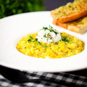 Tinned crab and saffron risotto served with dill and garlic bread.