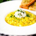Canned crab and saffron risotto served with dill and garlic bread.