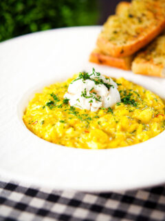 Canned crab and saffron risotto served with dill and garlic bread.