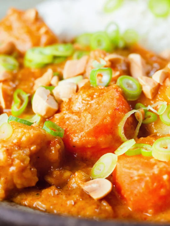 Close-up domoda a West African stew, vegan version with sweet potato and carrot, served with rice.